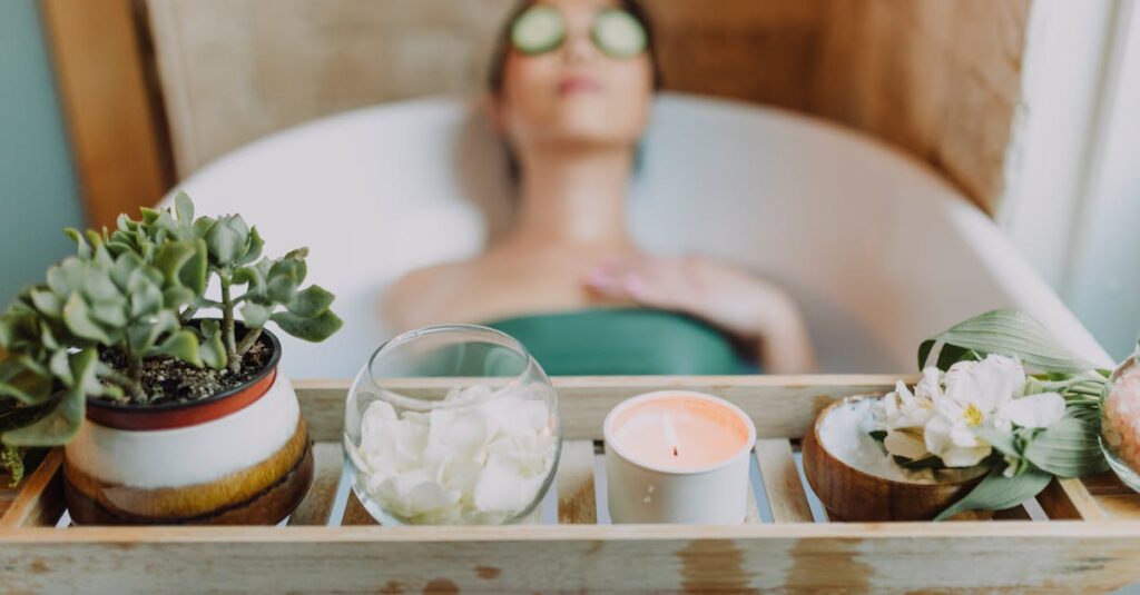 Woman relaxing in a bathtub with a candle and plants, enjoying a serene spa experience.